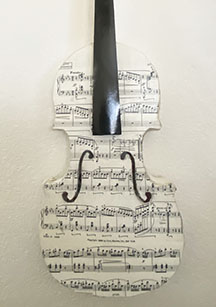 A Novel Twist on that "Ole Summer Reading" Violin made to look like Sheet Music. This is called the Pages in Harmony Violin by Vera Lowdermilk.