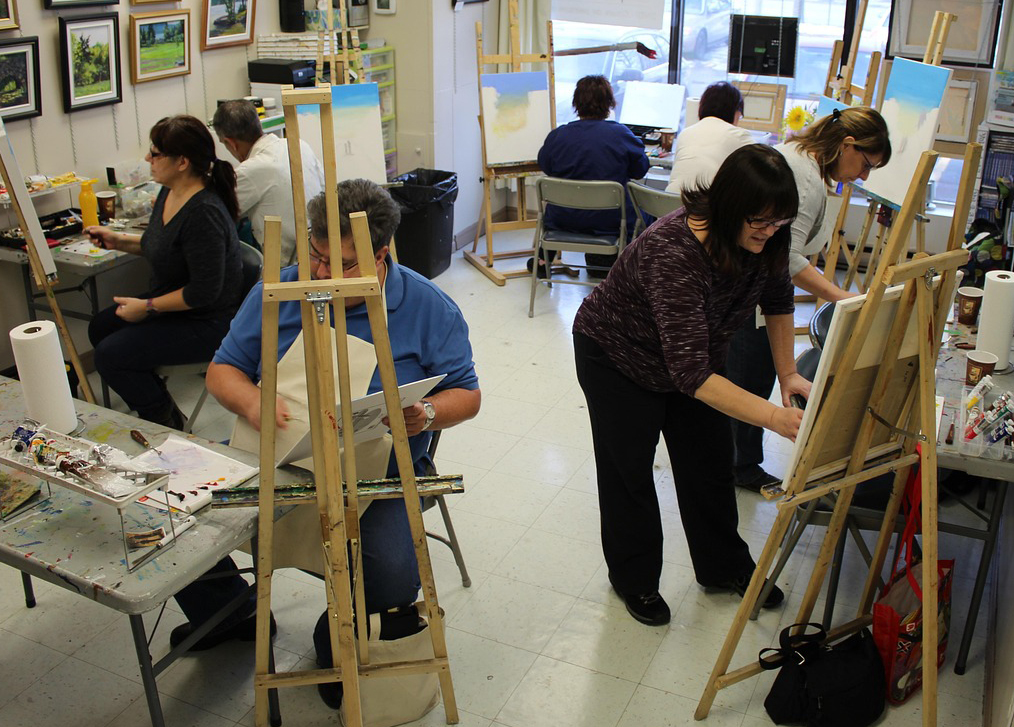 Adults painting at an easel