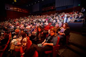 Audience members sitting inside the Bankhead Theater.